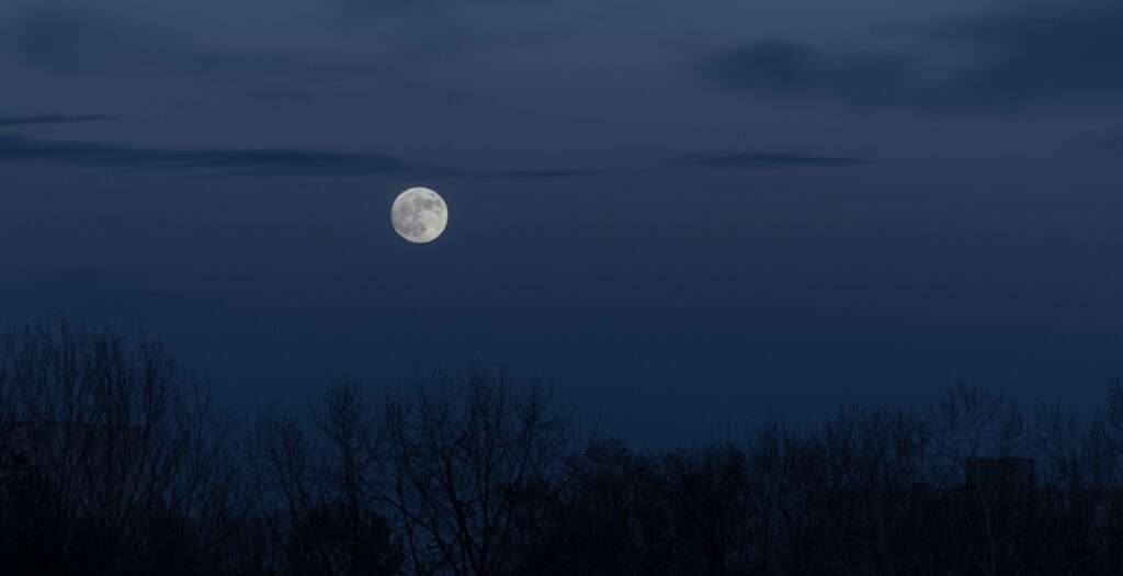 luna piena nel cielo scuro durante il sorgere della luna